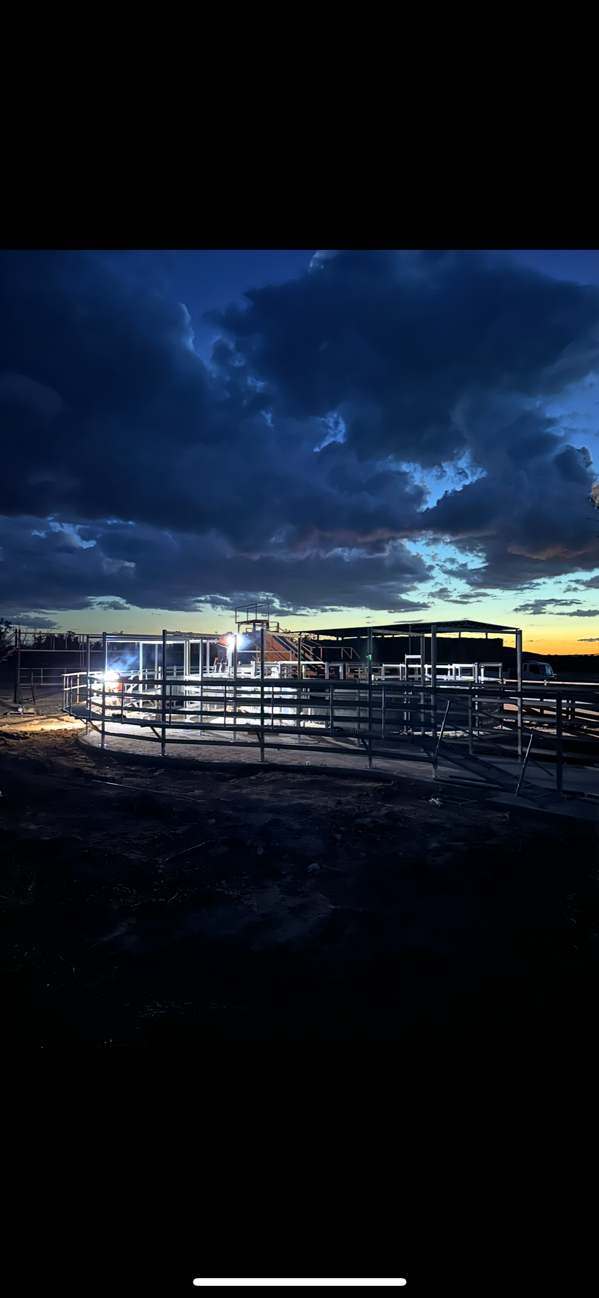 Frizzell Industries overnight yard construction — dramatic stormy sky